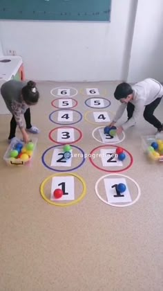 two children are playing with numbers on the floor