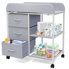 a baby changing table with three drawers and two diaper bins next to it