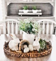 a basket with some plants in it on top of a table