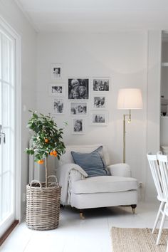 a white living room with pictures on the wall