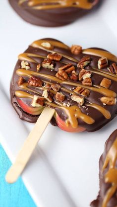 chocolate covered apple with caramel drizzled on top and pecans in the middle