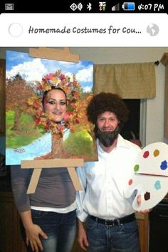 a man and woman standing next to each other holding paintings