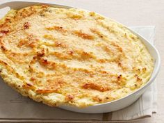 a casserole in a white dish on top of a napkin