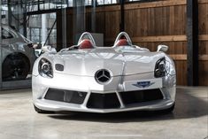 a white sports car parked in a garage