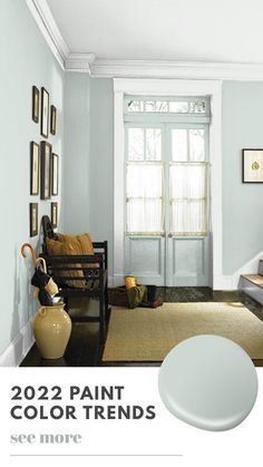 a living room with blue walls and pictures on the wall, including a white paint color