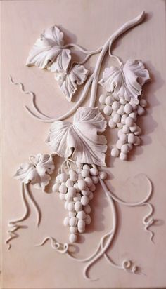 an intricately designed wall panel with grapes on it