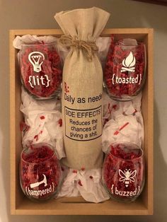 a wooden box filled with red candies and wrapped in burlied paper bags