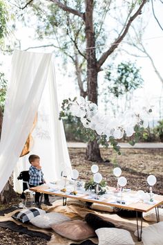 an instagram page with a little boy sitting at a table in the middle of it