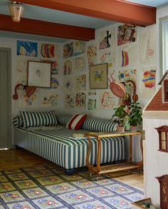 a living room filled with furniture and pictures on the wall