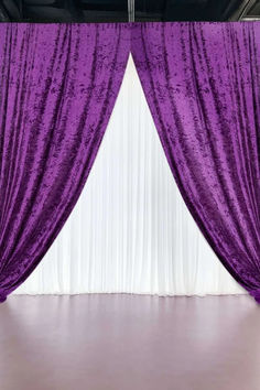 the purple curtains are hanging on the wall