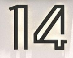 the number four is shown in black on a white sign that says, 4 11