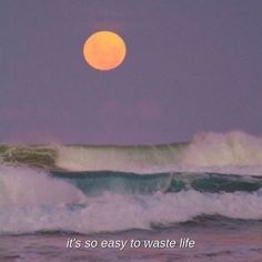 a full moon is seen over the ocean waves