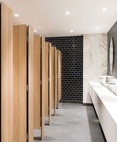 a row of wooden stalls in a public restroom