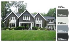 a gray house with white trim on the front and side windows, grass in front