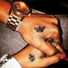 two people with matching tattoos on their hands