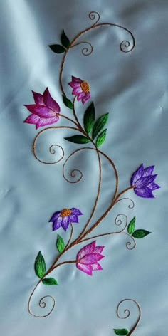 an artistically designed piece of cloth with flowers and vines painted on the fabric,