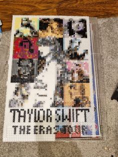 there is a cross stitch poster on the floor