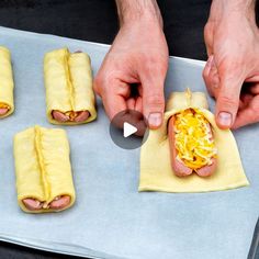 someone is making hot dogs with cheese and mustard