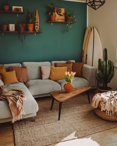 a living room with a couch, coffee table and potted plants