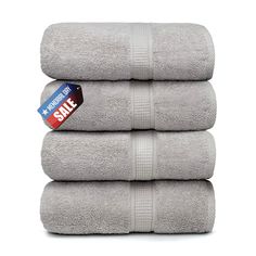 three towels stacked on top of each other with a sale tag attached to the towel