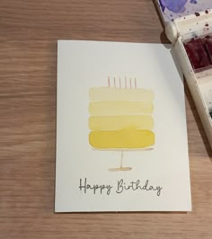 a birthday card with a cake on it and the words happy birthday written in black ink