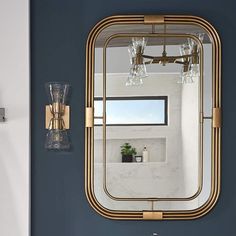 a bathroom with blue walls and gold fixtures