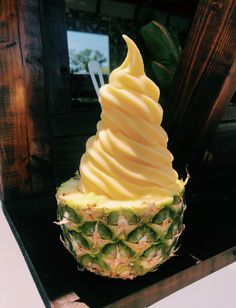 a pineapple topped with whipped cream on top of it