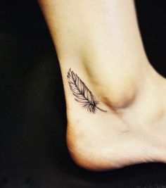 a woman's foot with a small feather tattoo on the side of her leg