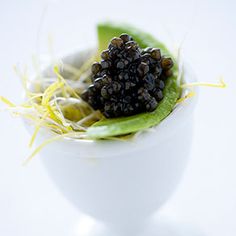 a white bowl filled with food on top of a table