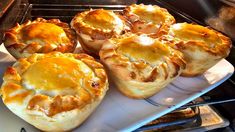 several baked goods are sitting on a plate in the oven, ready to be cooked