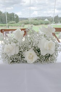 some white flowers are sitting on a table