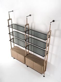 a shelf with three shelves and two bins on each side, against a white wall