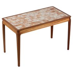 a wooden table with tile top and legs