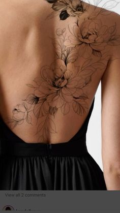 the back of a woman's dress with flowers on her upper and lower back