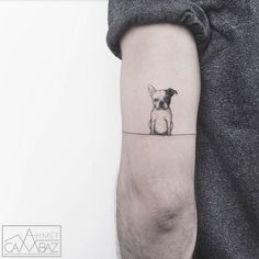 a small dog tattoo on the left inner arm, with an instagram message below it