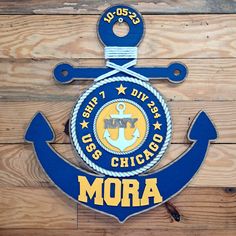 an anchor with rope and the word chicago on it is mounted to a wooden wall