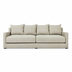 a white couch with four pillows on the back and one arm folded out to show it's fabric