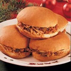 three sandwiches stacked on top of each other on a white plate with christmas decorations in the background