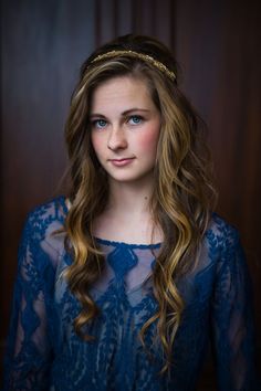 a woman with long hair wearing a tiara and posing for a black and white photo