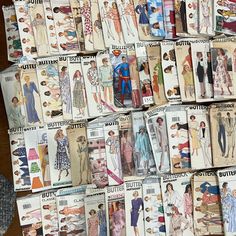 lots of vintage sewing patterns are stacked on top of each other