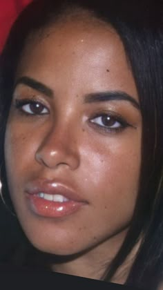 a close up of a woman's face with brown eyes