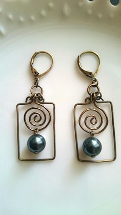 two pairs of earrings sitting on top of a white plate