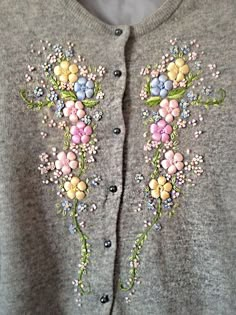 an embroidered sweater with flowers on it