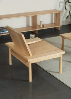 a wooden table sitting on top of a carpeted floor