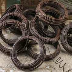 several coils of brown wire sitting on top of a stone floor next to a box