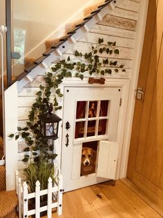 a dog is sitting in the door to his house that has plants growing on it