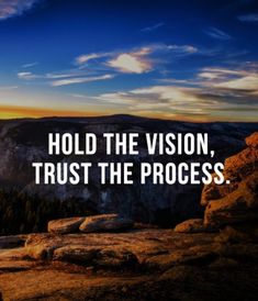 the words hold the vision, trust the process on top of a mountain at sunset