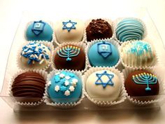 a box filled with lots of different types of chocolates on top of a table