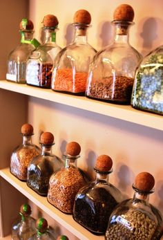 several bottles filled with different types of spices