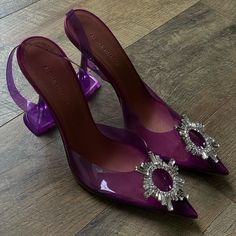 An Italian-Made Pump For The Most Glam Of Cinderellas Gets Its Ethereal Look From A Clear Upper Crowned With An Opulent Jeweled Ring. Amina Muaddi's Kick-Flare Heel Is The Signature Finish. Chic Purple Slingback Pumps For Formal Occasions, Chic Purple Slingback Pumps For Formal Events, Purple Slingback Pumps With Heel Strap For Party, Elegant Purple Slingback Pumps, Elegant Purple Slingback Heels, Purple High Heel Slingback Pumps For Party, Purple Slingback Pumps For Party, Purple Slingback Heels For Formal Occasions, Muaddi Shoes